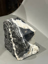 Pyramid sculpture emerging from the material
