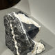 Pyramid sculpture emerging from the material